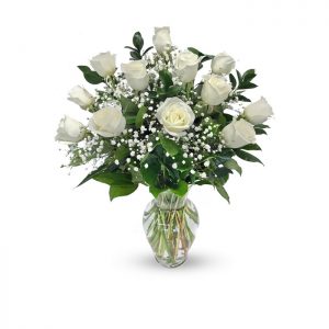 dozen white roses in vase with baby's breath